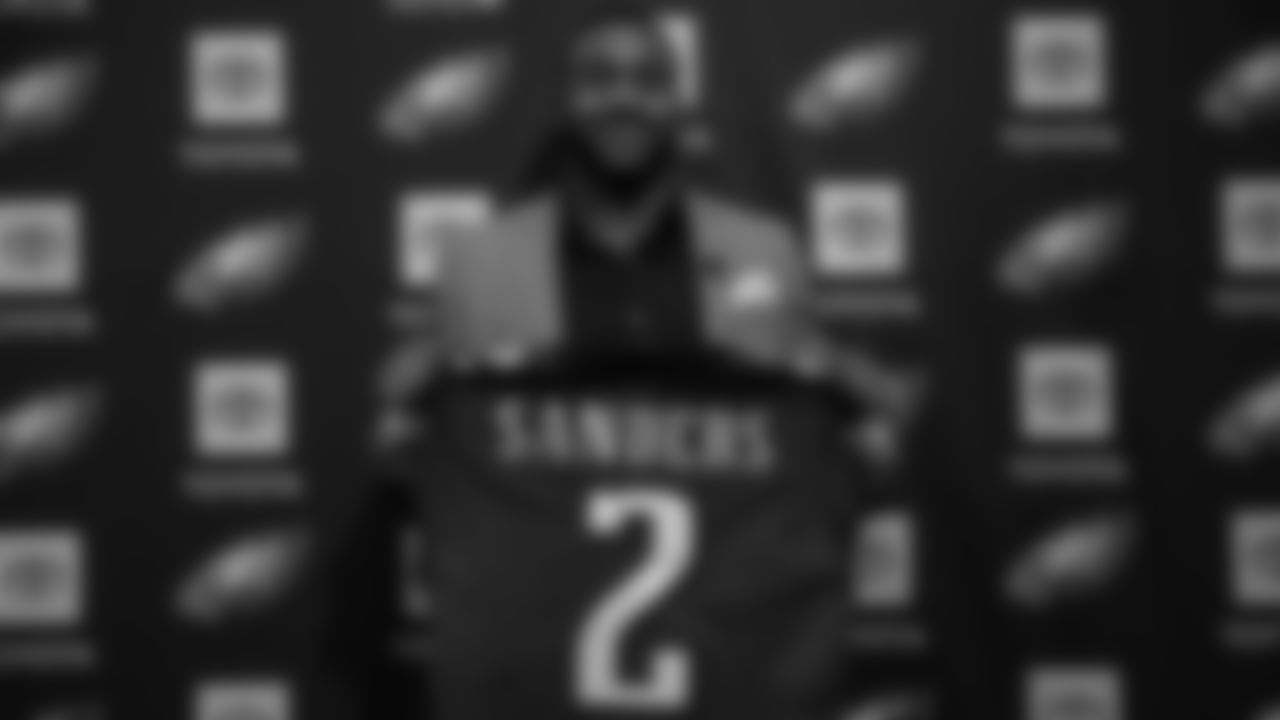 Miles Sanders holds up a jersey at his introductory press conference