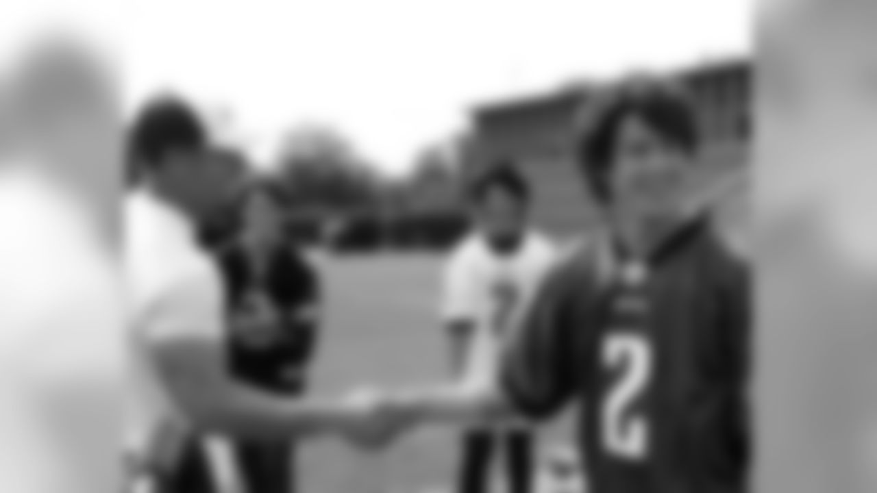 A handshake between K David Akers and Nick Jonas