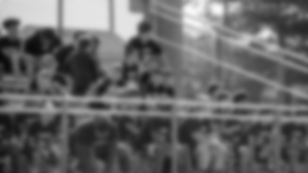 Camp participants gather on bleachers