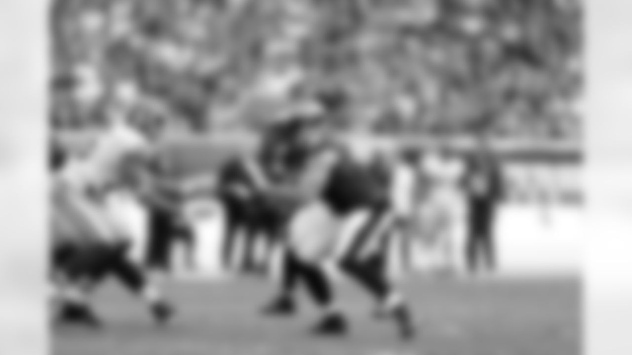 Eagles' offensive linemen and Redskins' defensive linemen battle at the line of scrimmage.