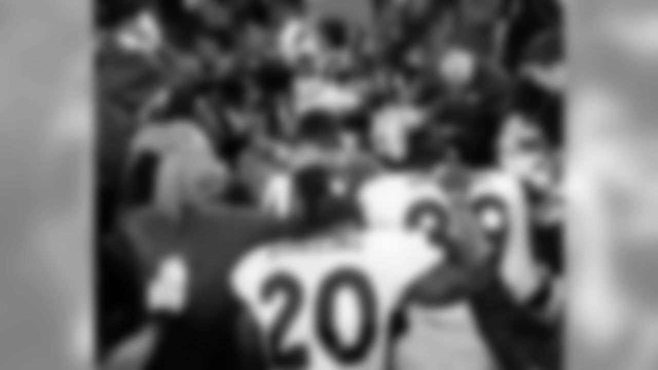 Eagles and Broncos players gather for a post-game prayer