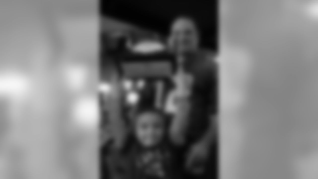 This young Eagles fan shows off the Trent Cole autographed football that he won