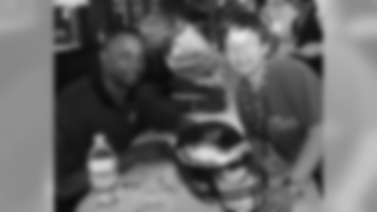 CB Troy Vincent poses with a youngster and his autographed Eagles helmet