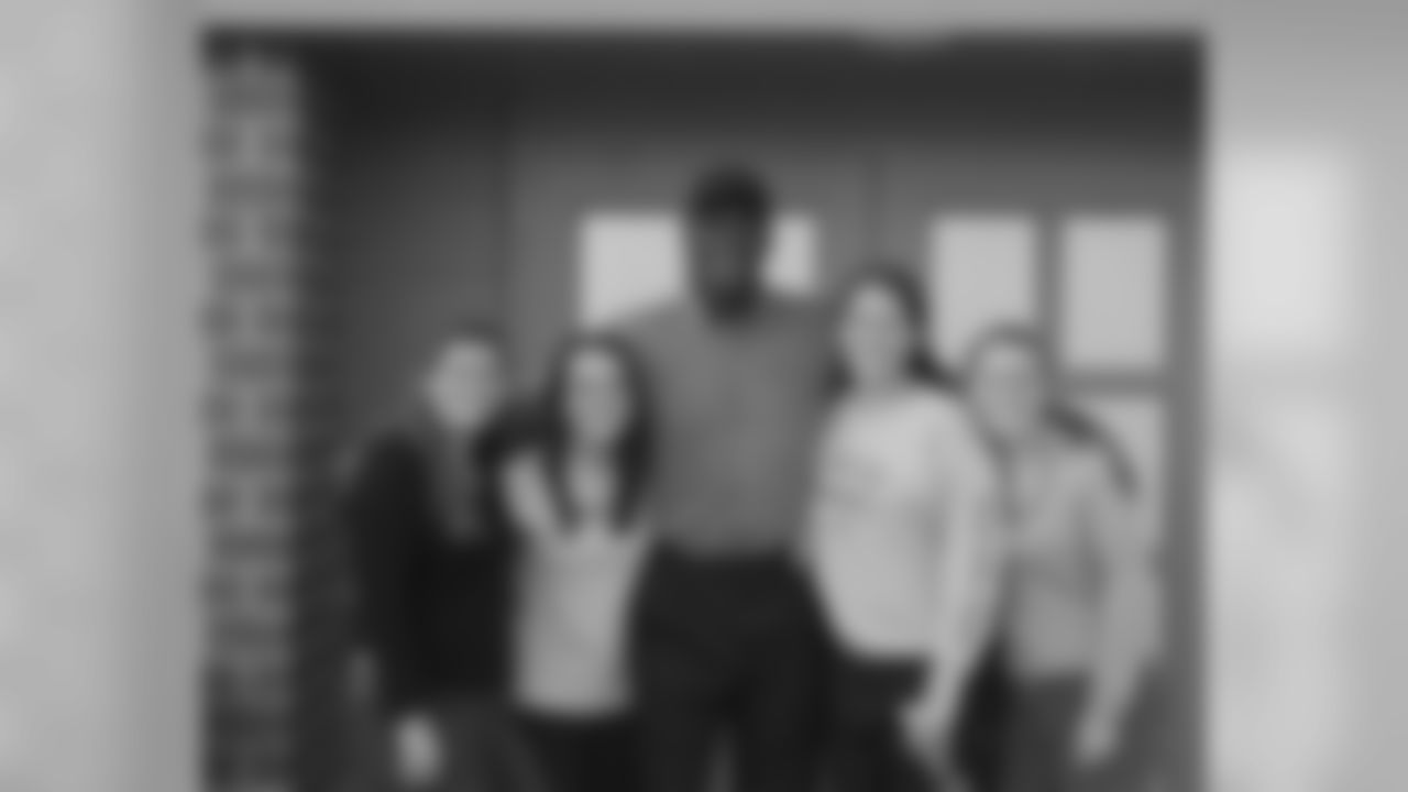 Harold Carmichael with Premium Services staff members, (from left) Liz Tierney, Maura McGarrity, Lauren Waitkus and Ellen Kleiman