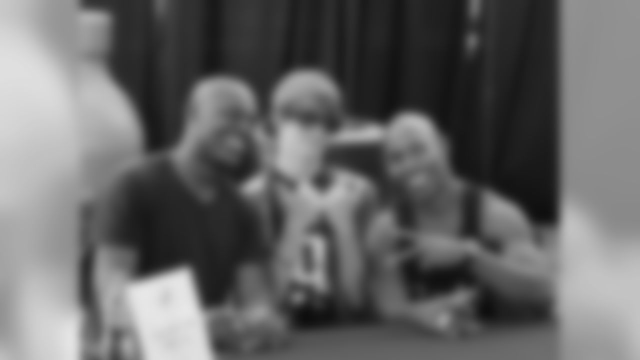 Former Eagles Fred Barnett and Vaughn Hebron pose for a photo