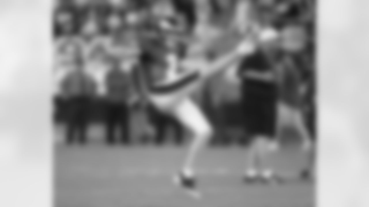 Punter Ken Parrish boots one up in the air