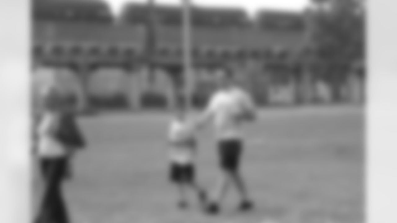Connor Barwin chats with a young fan as he crosses the field