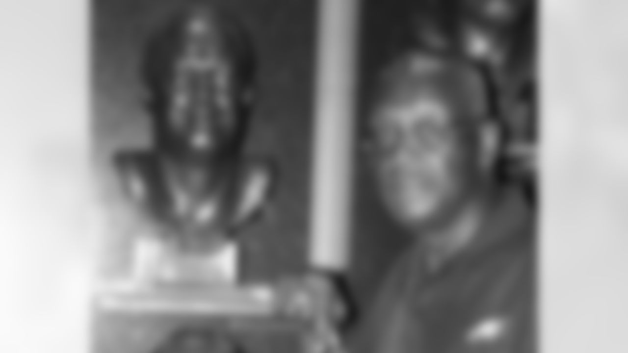 Harold Carmichael poses by the bust of his mentor, tight end John Mackey