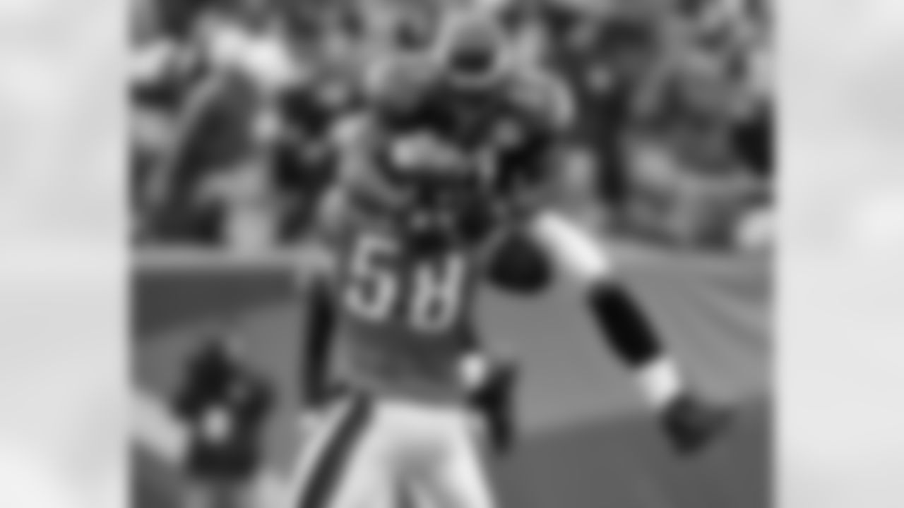 LB Takeo Spikes leaps on DE Trent Cole following Cole's sack