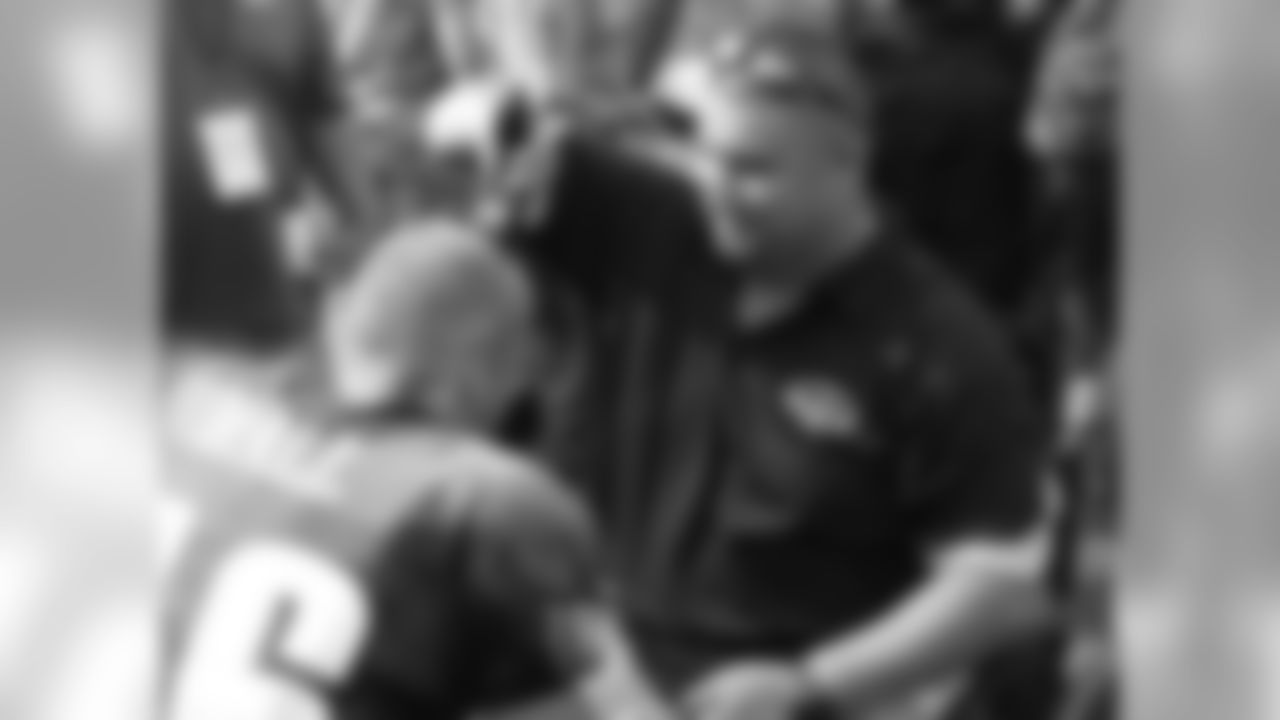 Sergeant Shane Parsons from the Wounded Warriors Project helps shave WR Chad Hall's head to raise money