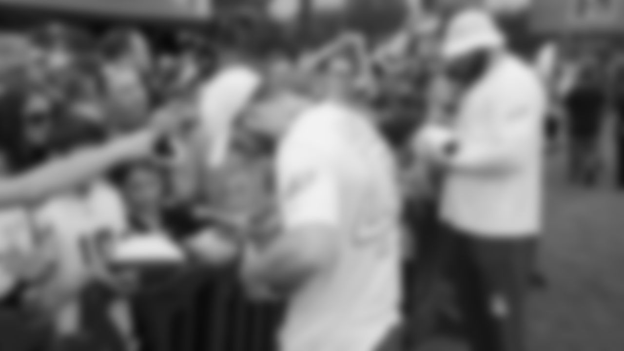 LS Rick Lovato and T Lane Johnson sign autographs following practice