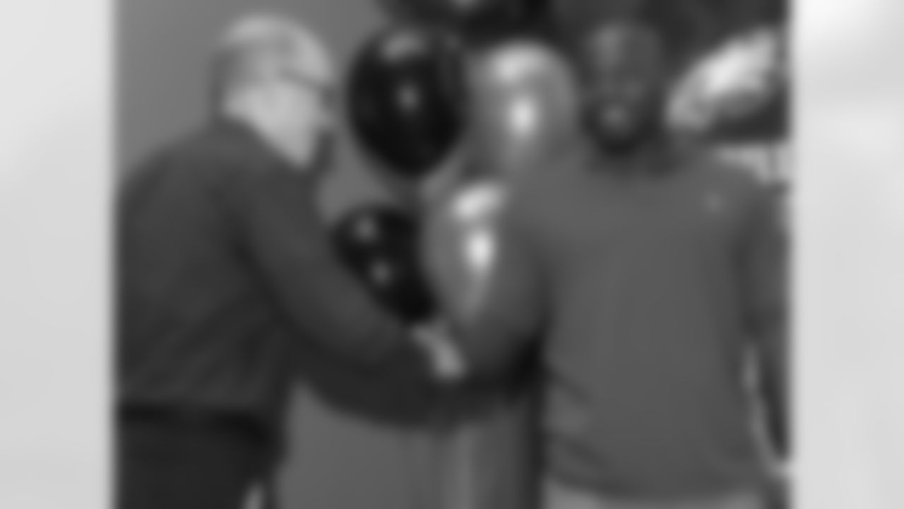 Jim Everett of the Old Pine Community Center shakes hands with defensive end Phillip Hunt