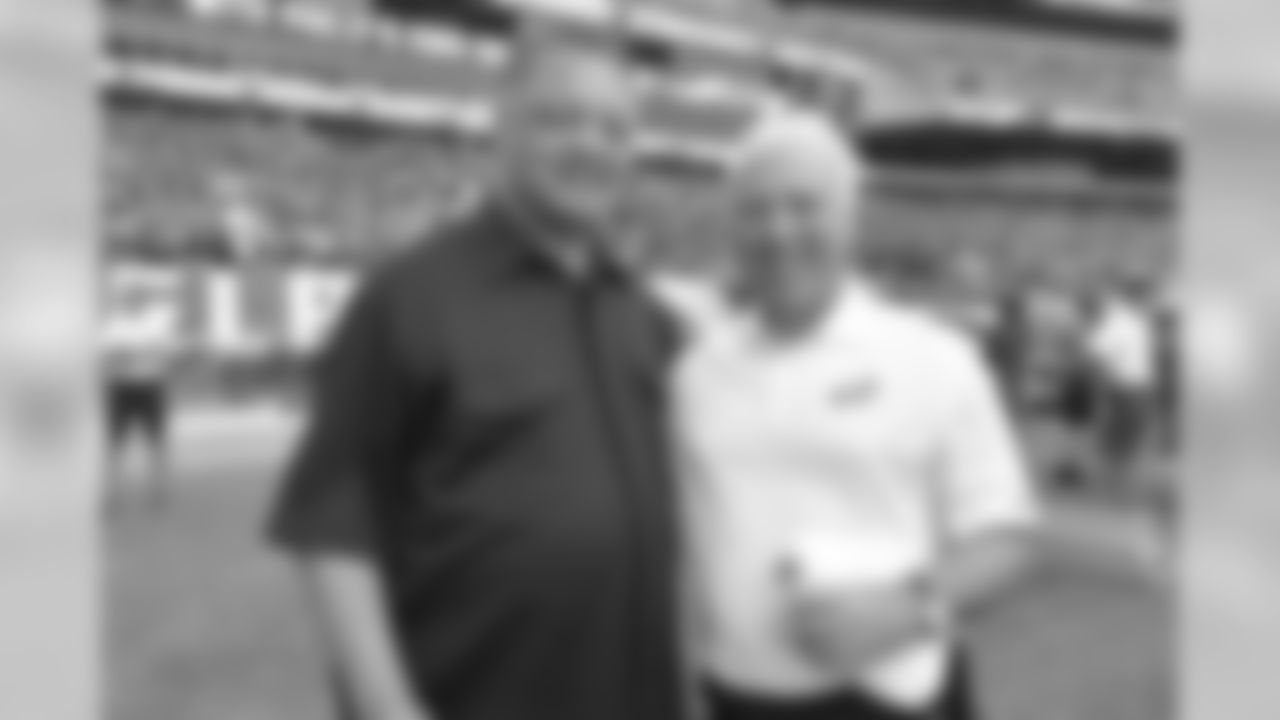 Rev. Jesse Jackson and Chairman and CEO Jeffrey Lurie take a photo on the sidelines during public practice.