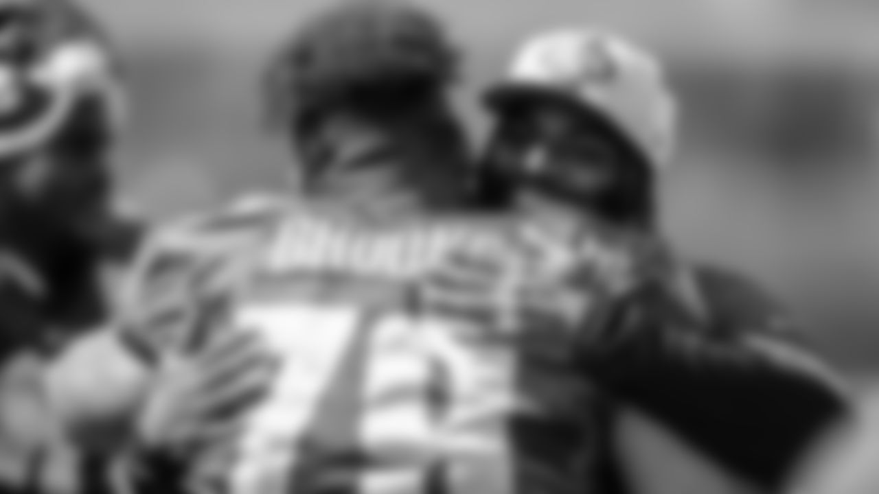 G Brandon Brooks hugging former Eagle and current Jet Vinny Curry