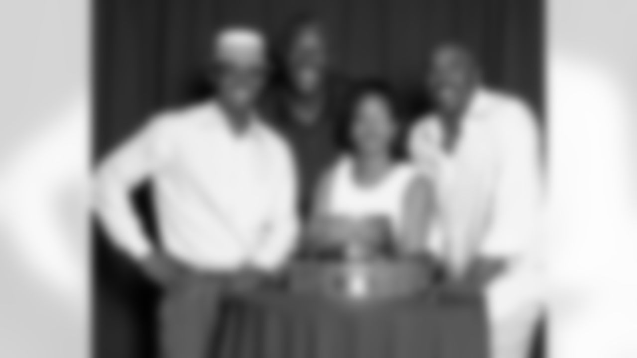 Cheryl D. Williams, Philadelphia Eagles Concierge, and Philadelphia Eagles Alumni, Fred Barnett, Harold Carmichael, and Mike Quick posing with the NFC Championship Trophy