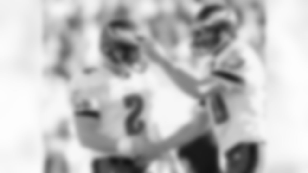 Holder Koy Detmer congratulates David Akers on the PAT