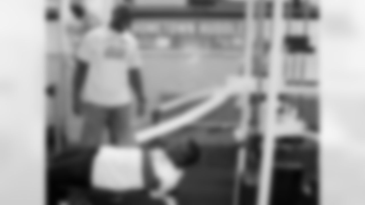 DeMeco Ryans worked with students individually as they tried out the new fitness zone weight machines