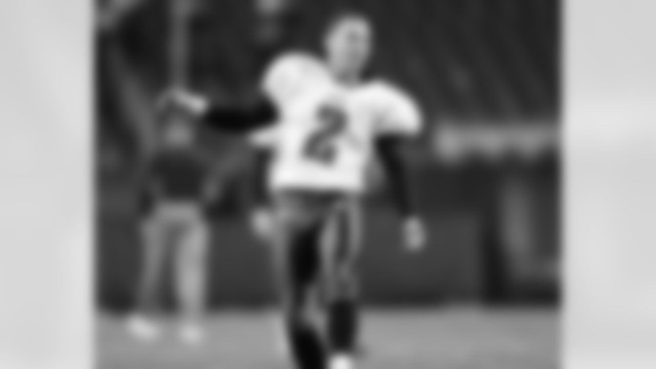K David Akers gets a read on the field conditions at Soldier Field