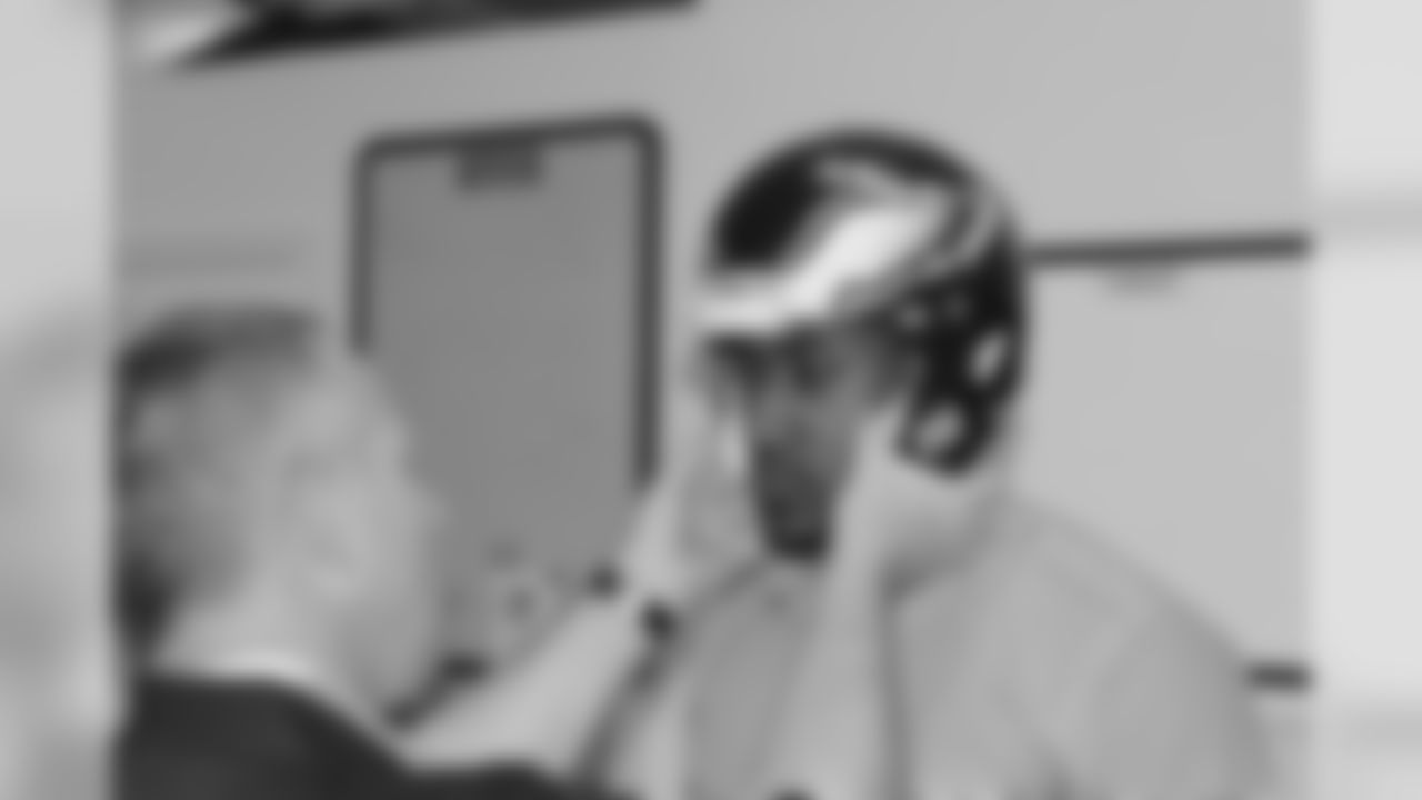 WR Marvin McNutt gets his helmet fitted properly