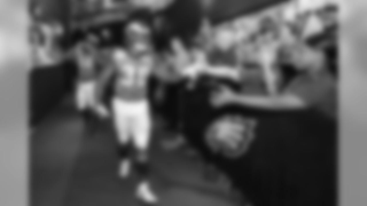 RB Corey Clement shakes military members hands in the tunnel.