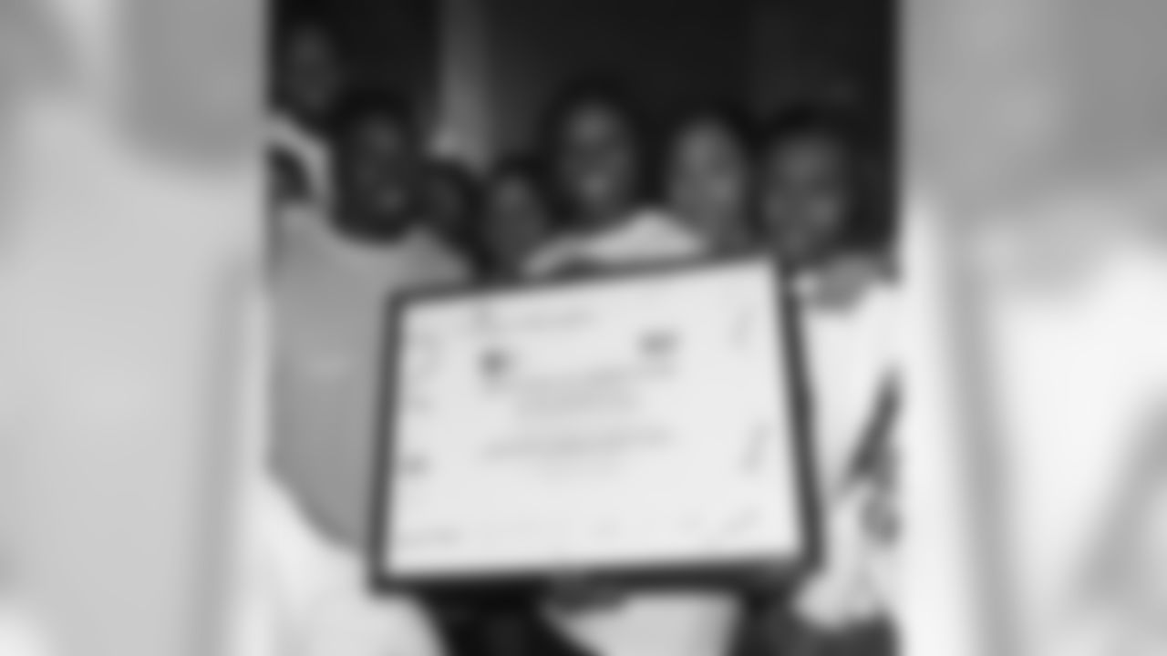 Dollar 4 Dollars and its parent company, West Philadelphia Financial Services Institution, presented Brian Westbrook with a certificate of appreciation