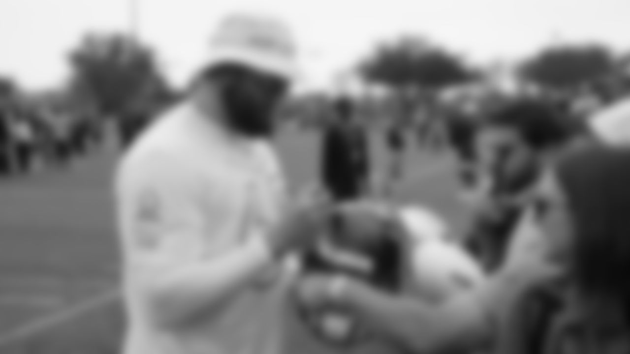 T Lane Johnson signs an Eagles helmet