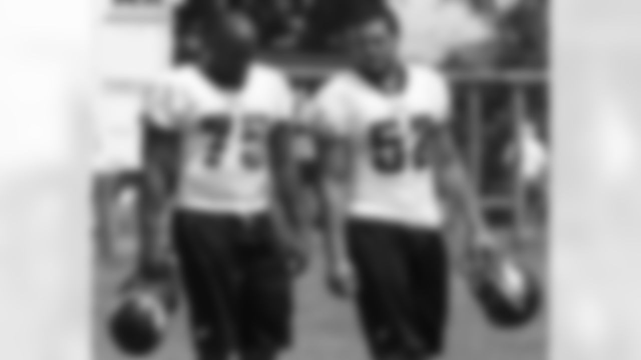 DE Daniel Te'o-Neshiem talks with DE Jaqua Parker