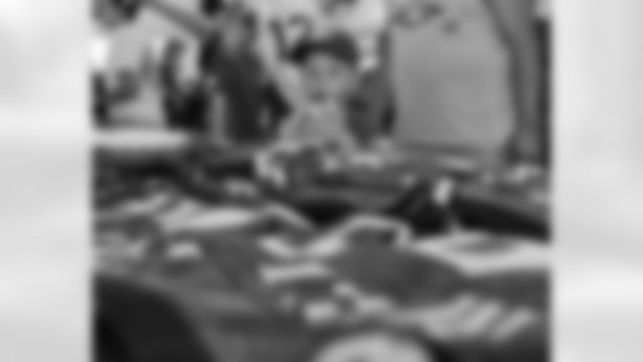 A fan observes all of the jerseys displayed in the Pro Shop