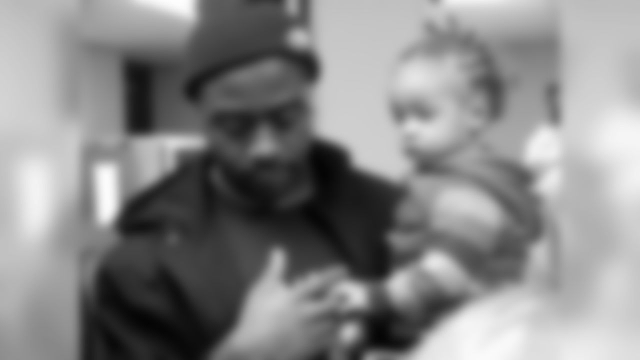 Keenan Clayton, #57, enjoys the company of a new member of Eagles Nation.