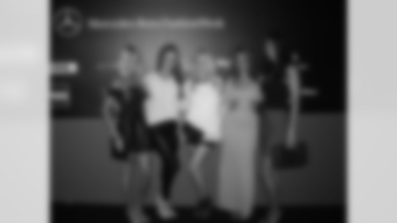 Cheerleaders posing for media on red carpet at The Lincoln Center for New York Fashion Week
