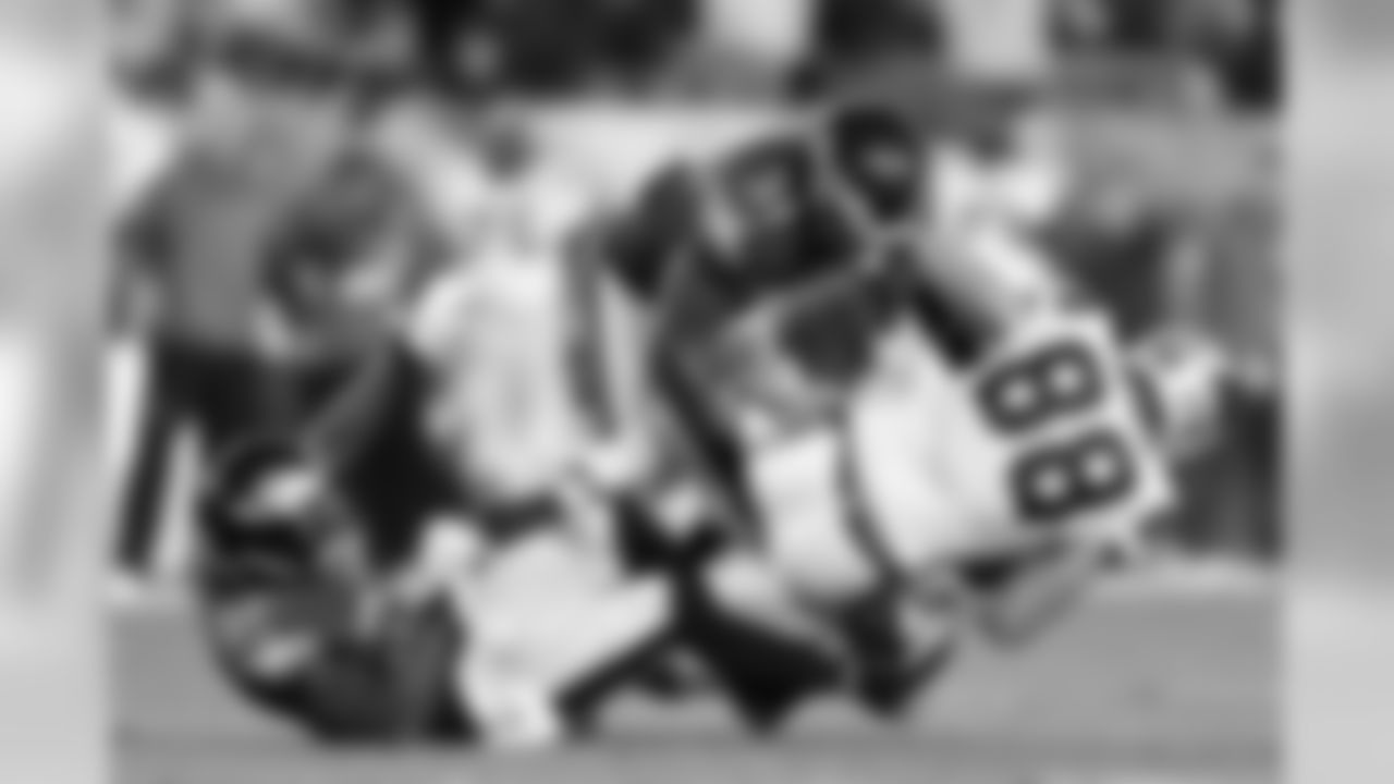 S Malcolm Jenkins and LB Emmanuel Acho take down a Panthers player