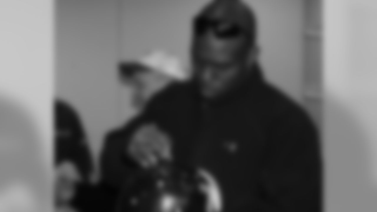 DE Trent Cole signs a helmet