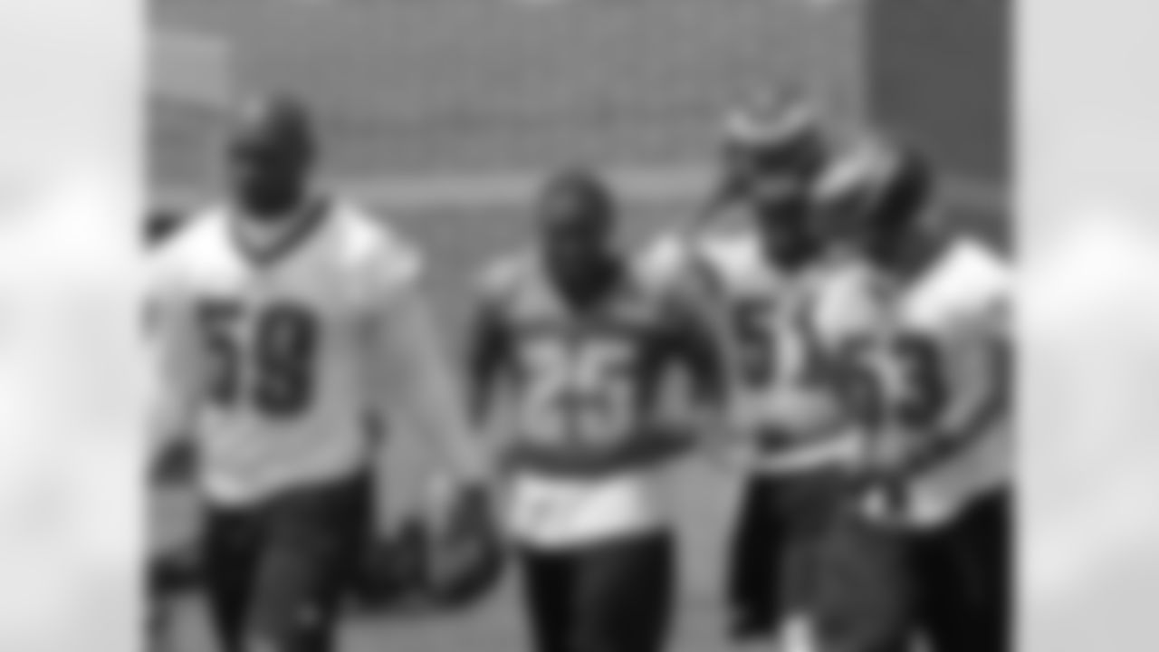 LB DeMeco Ryans leads some of the Eagles out to the practice fields