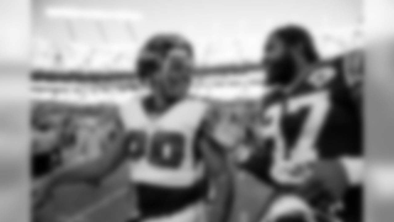 Atlanta Falcons running back Qadree Ollison #30 with Carolina Panthers linebacker Mario Addison #97 after the game at Bank of America Stadium in Charlotte, NC, on Sunday November 17, 2019. (Photo by Kara Durrette/Atlanta Falcons)