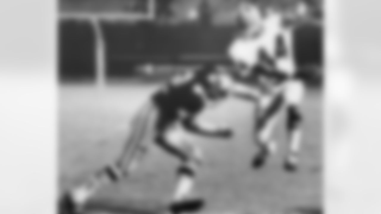 Atlanta Falcons' end Jerry Simmons is tackled by New Orleans DT Earl Leggett on August 31, 1968