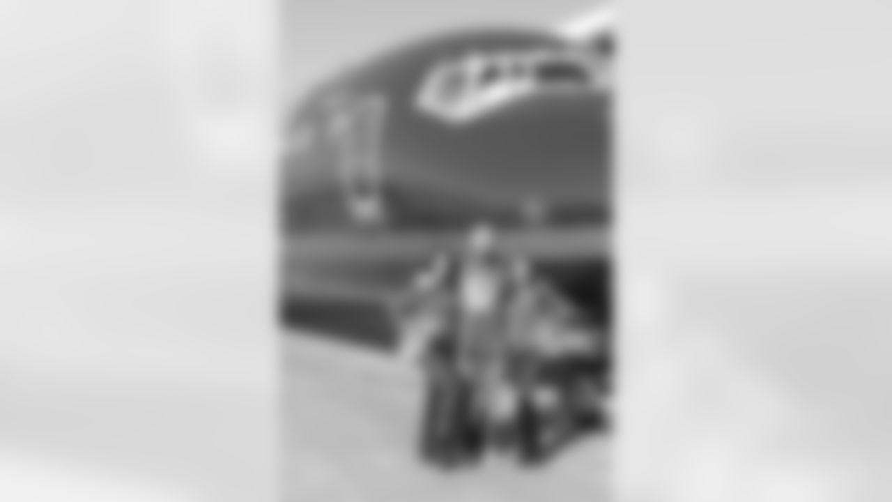 Several Falcons traded places with AirTran workers to marshal planes, take tickets and greet passengers // Trading Places - AirTran // Nov. 1, 2011 // Atlanta -