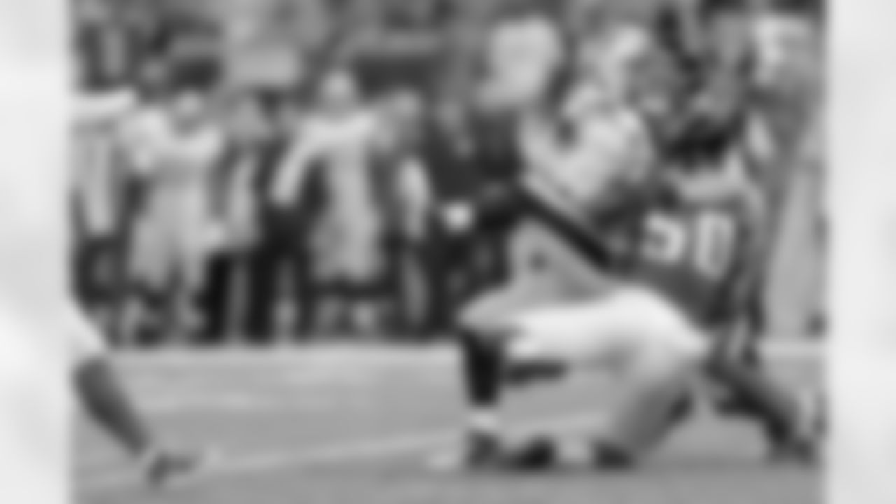 DE Osi Umenyiora and DE Kroy Biermann bring down Saints QB Drew brees