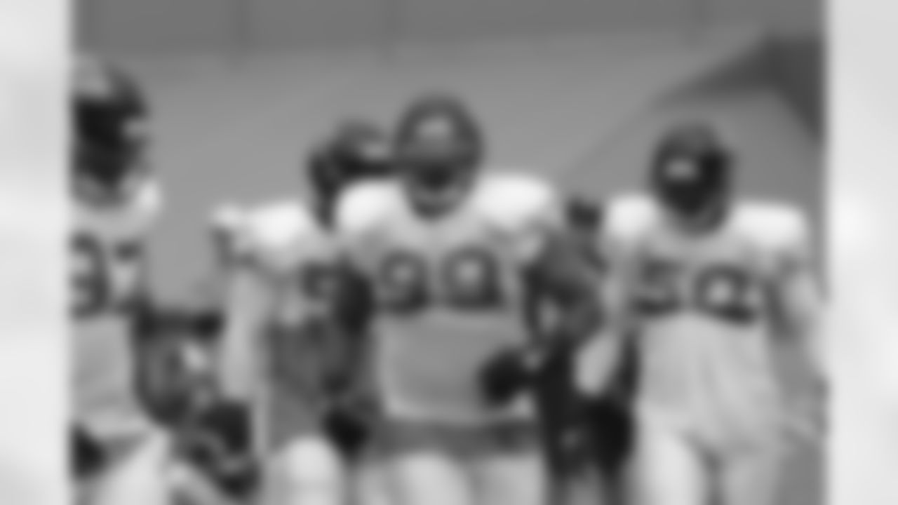 DT Vance Walker comes off the field with LB Curtis Lofton (50) and DT Trey Lewis (97) // 2011 Russell Athletic Training Camp - Day 7 // August 7, 2011 // Flowery Branch, Ga. -