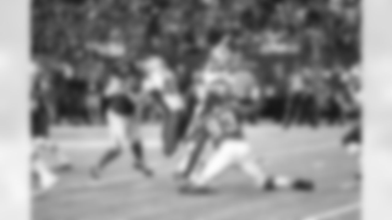 DE Malliciah Goodman puts pressure on Patriots QB Tom Brady