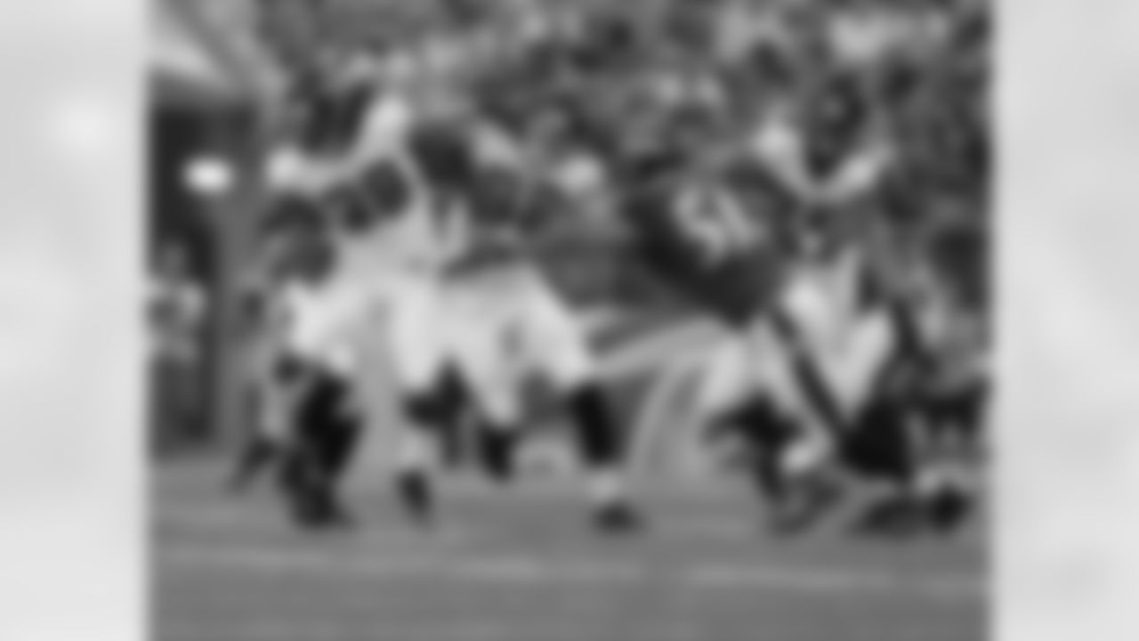 TE Chase Coffman and T Lamar Holmes hold off Ravens LB Daryl Smith so RB Steven Jackson can move the ball