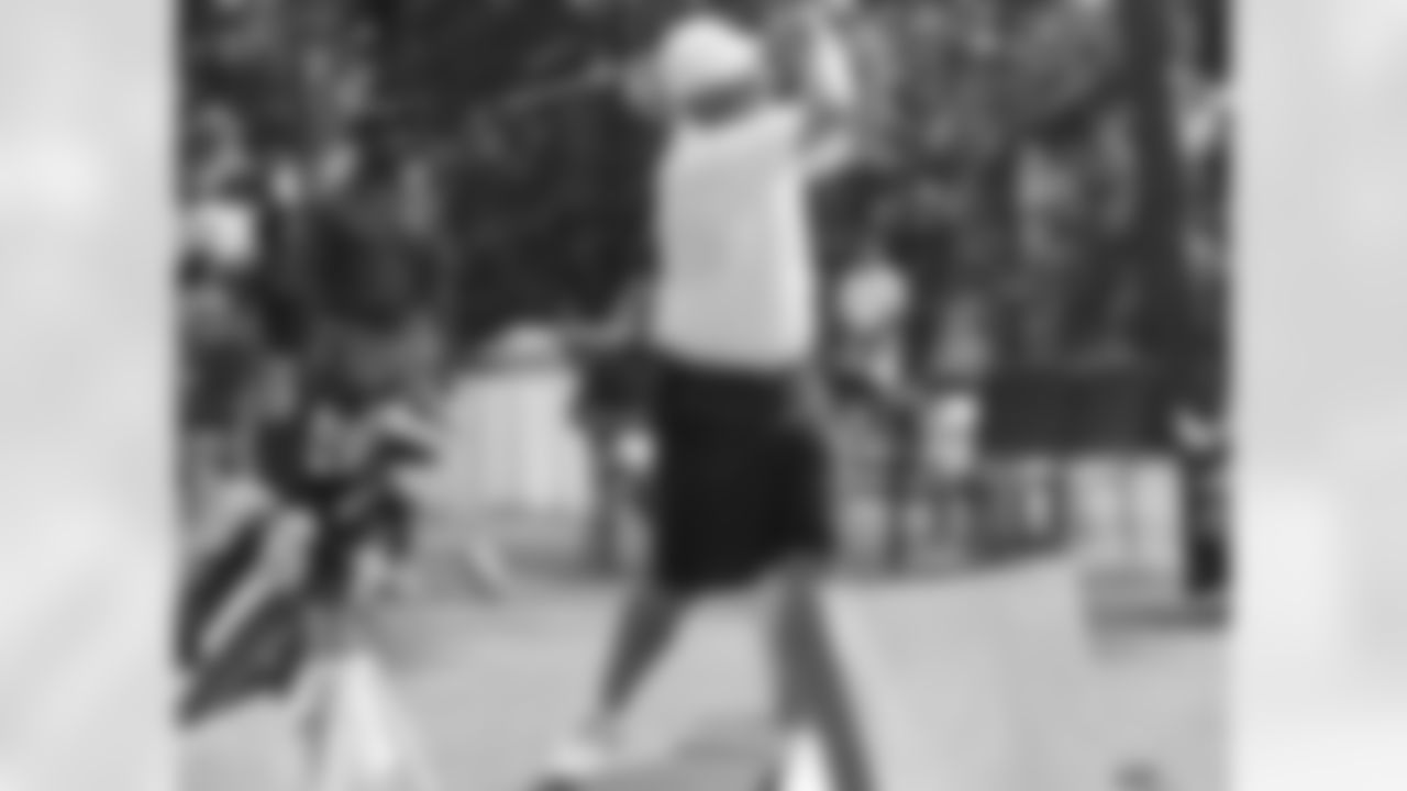 Coach Smith tees off in his celebrity-only closest to the pin contest after the tournament while former Falcons defensive back Henry Jones looks on // Seventh Annual Verizon Network of Champions Golf Tournament // 6/13/11 // Suwanee, Ga. -