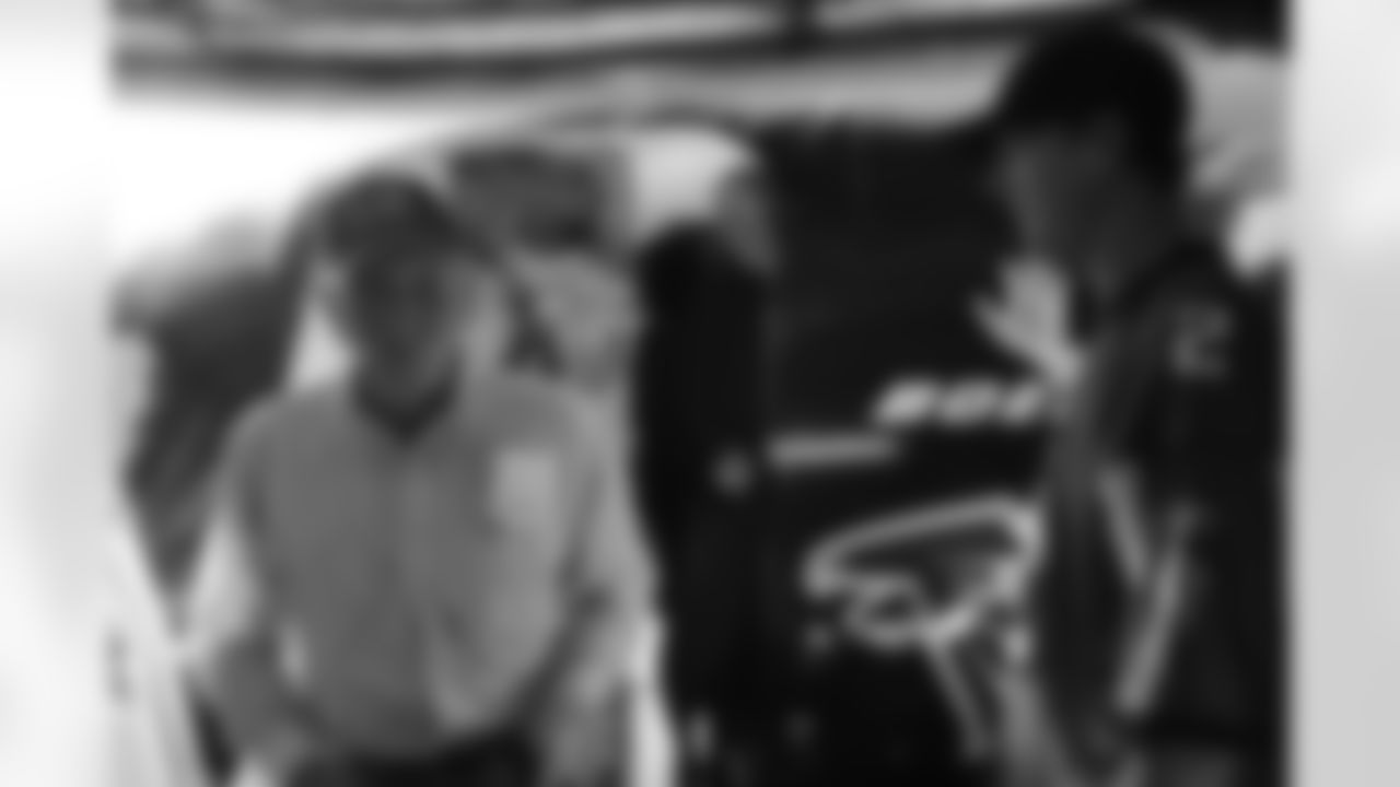 Several Falcons traded places with AirTran workers to marshal planes, take tickets and greet passengers // Trading Places - AirTran // Nov. 1, 2011 // Atlanta -