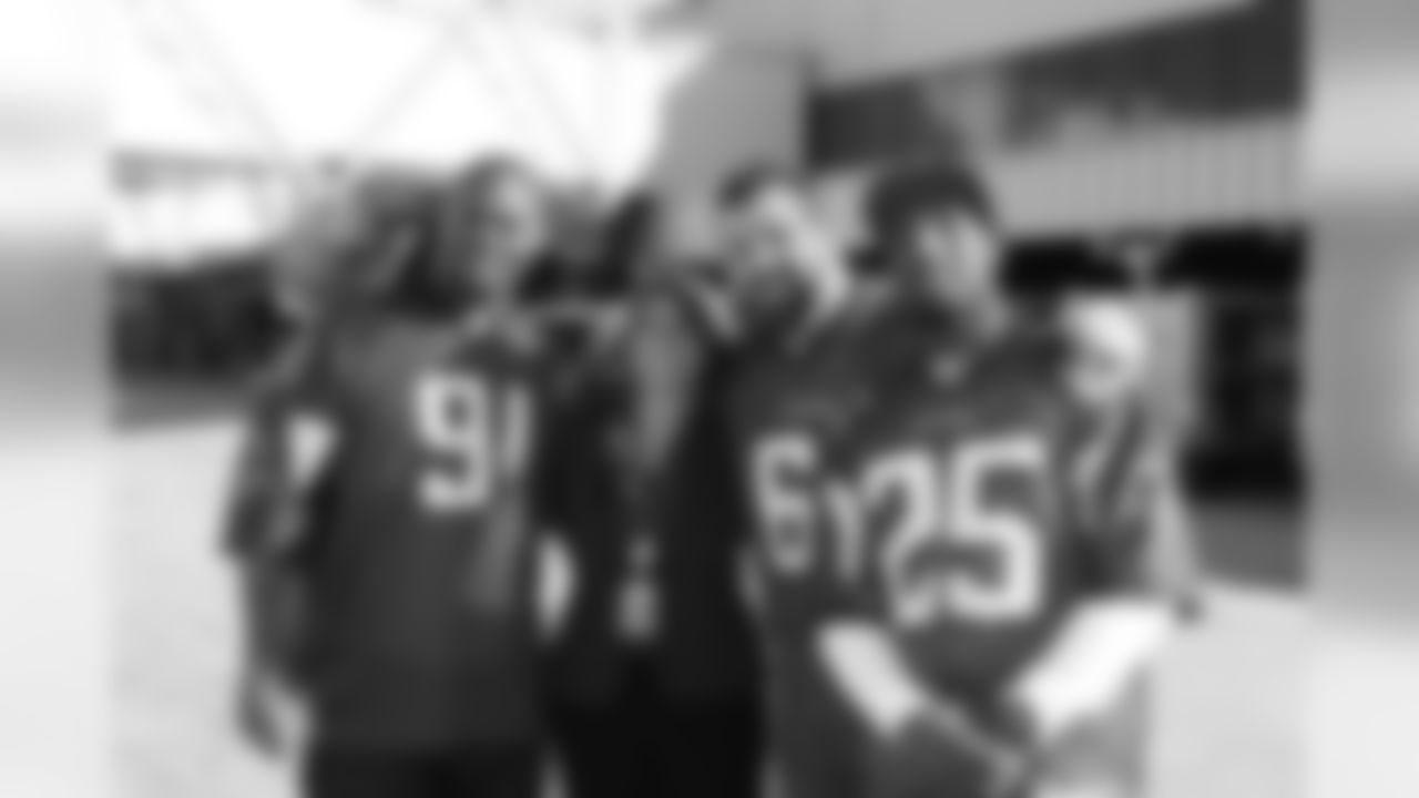 Several Falcons traded places with AirTran workers to marshal planes, take tickets and greet passengers // Trading Places - AirTran // Nov. 1, 2011 // Atlanta -