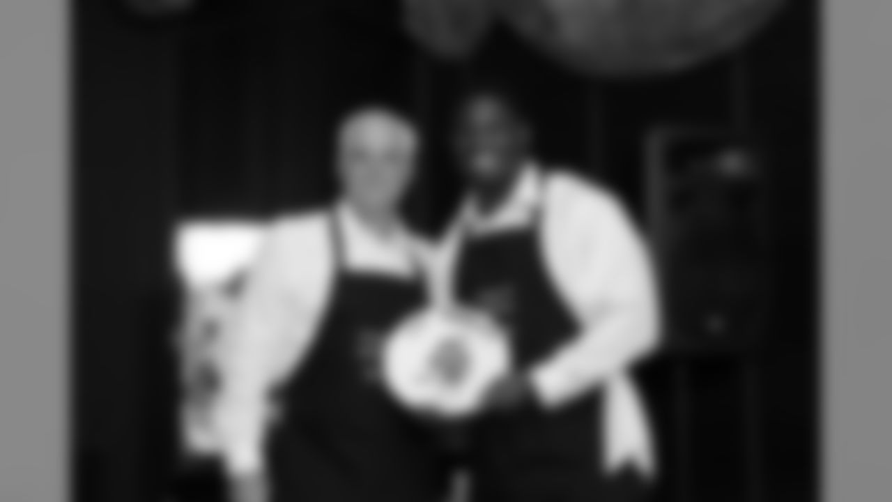 Linebacker Sean Weatherspoon and Head Coach Mike Smith pose during the 2012 Huddle Up for Miracles charity event at Capital Grille in Buckhead on Monday night // 2012 Huddle Up for Miracles // April 30, 2012 // Atlanta -