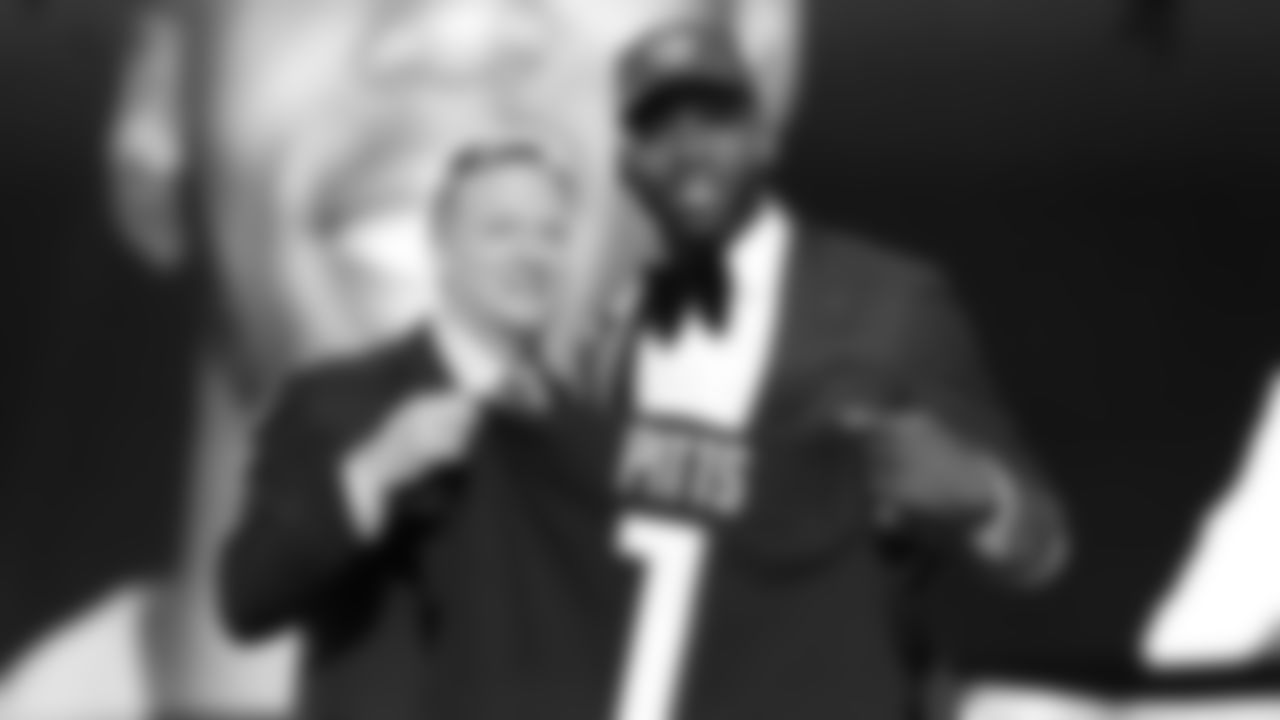 Florida tight end Kyle Pitts, right, holds a team jersey with NFL Commissioner Roger Goodell after the Atlanta Falcons selected Pitts with the 4th pick in the first round of the NFL football draft Thursday April 29, 2021, in Cleveland. (AP Photo/Gregory Payan)