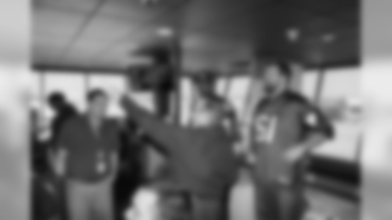 Several Falcons traded places with AirTran workers to marshal planes, take tickets and greet passengers // Trading Places - AirTran // Nov. 1, 2011 // Atlanta -