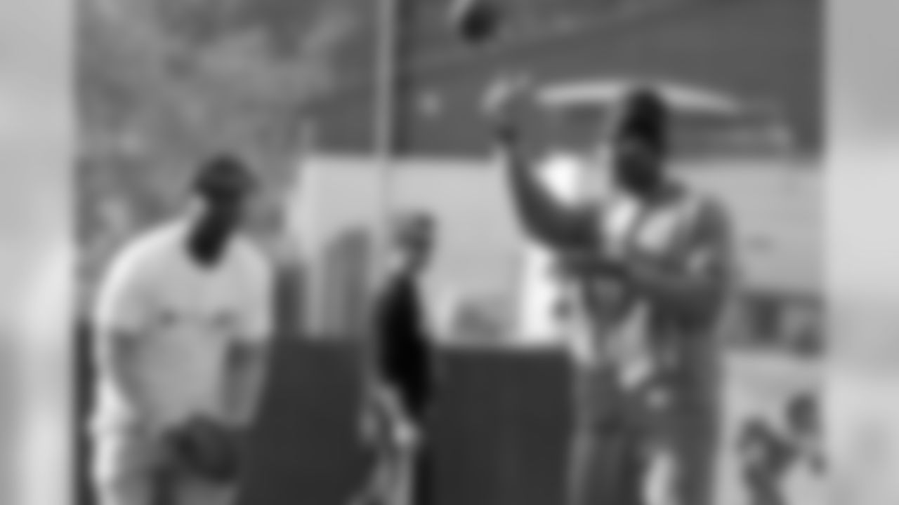 WR Julio Jones and WR Devin Hester pass with the kids