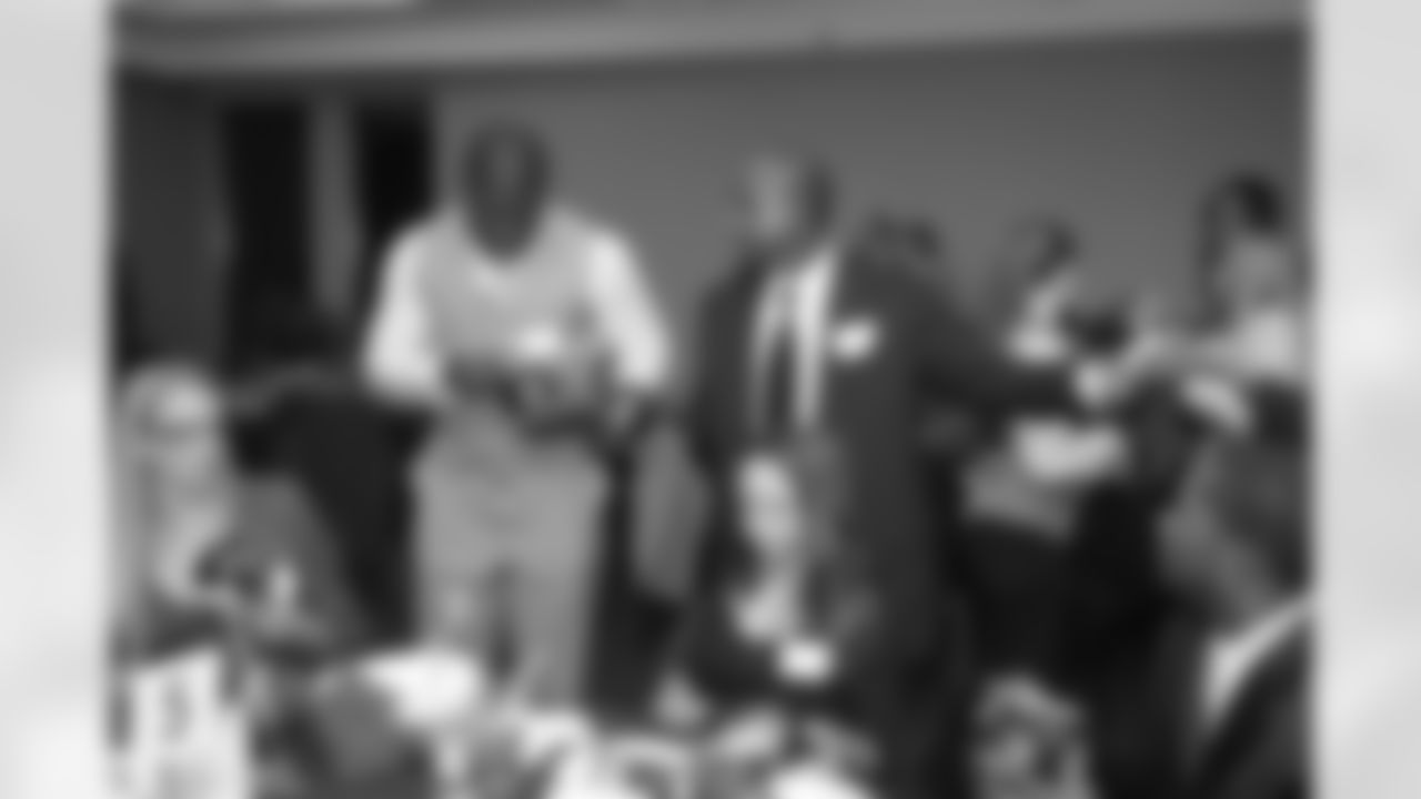 FB Ovie Mughelli and WR Harry Douglas sign some mini helmets // 2011 Falcons Community Honors Dinner // Dec. 5, 2011 // Atlanta -