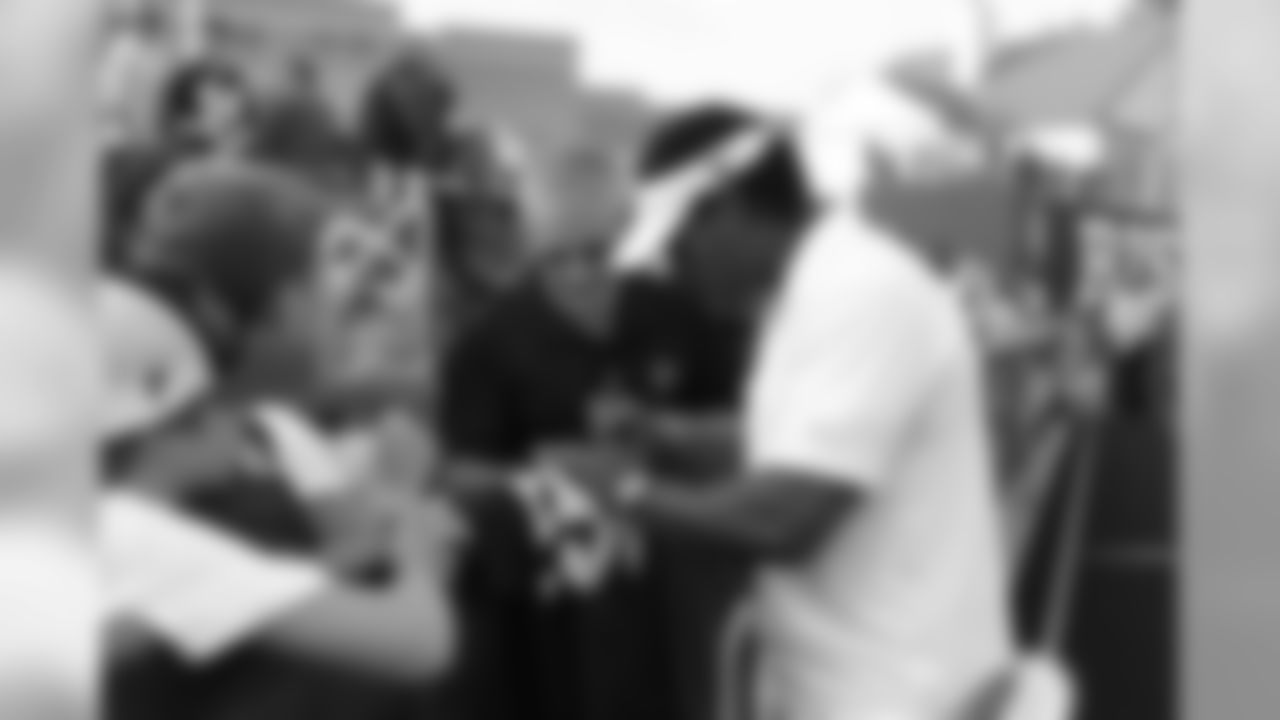 Falcons legend Jessie Tuggle signs for a fan // 2011 Friday Night Lights // August 5, 2011 // Norcross, Ga. —