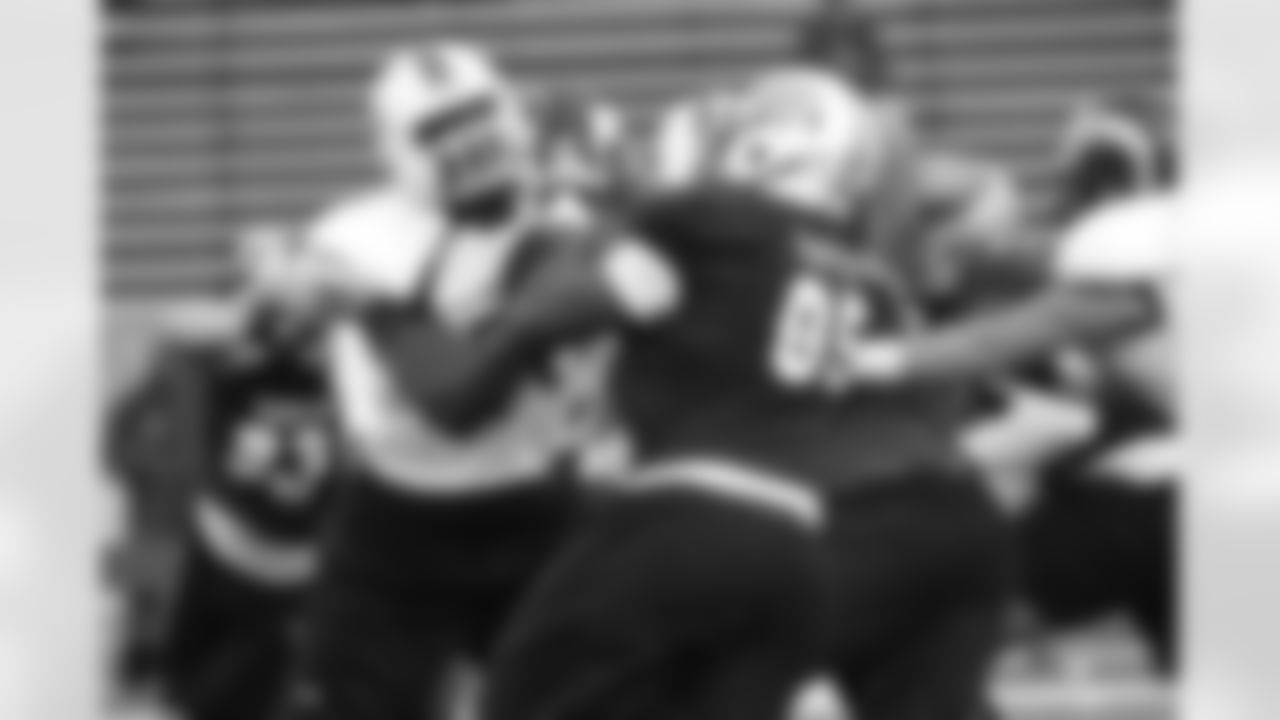 Miami's Seantrel Henderson, left, locks up with North Carolina DE Kareem Martin.